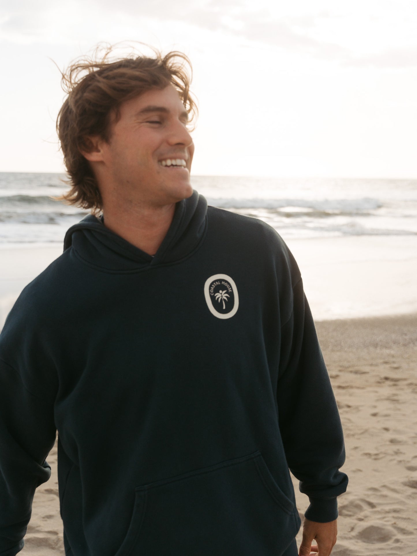 man in blue coastal house hoodie