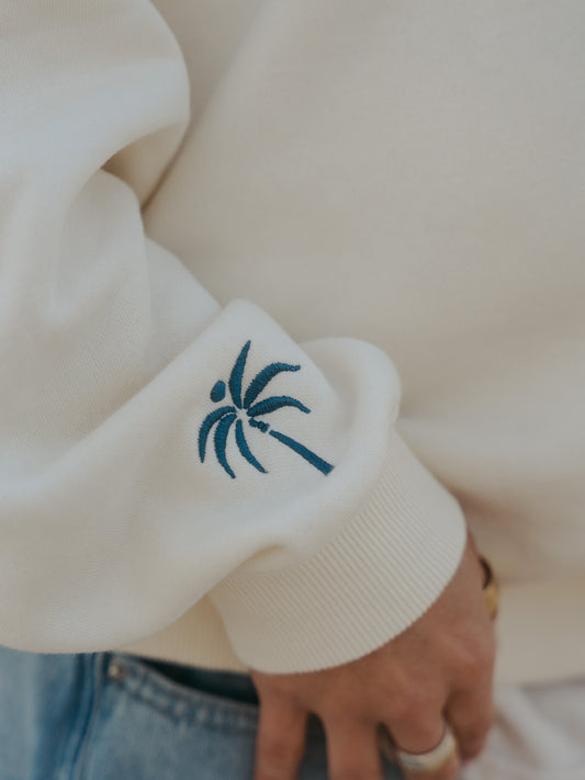 palm tree on sleeve of crewneck