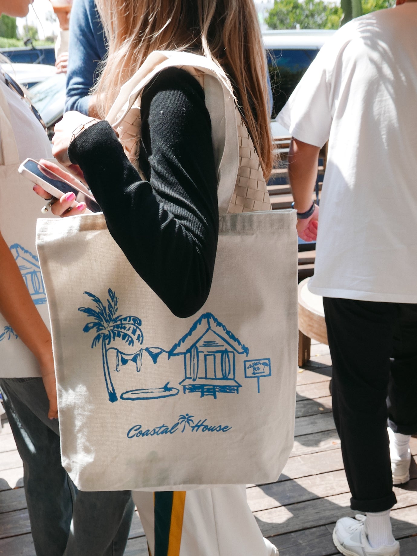 girl holding beach tote bag